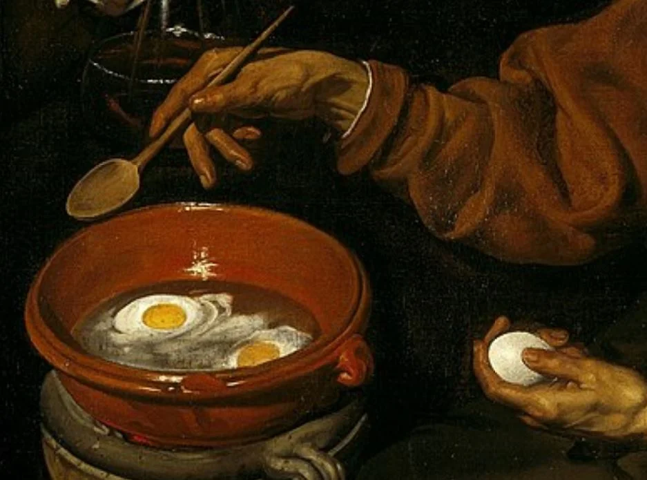 Old woman frying eggs detail of the ggs